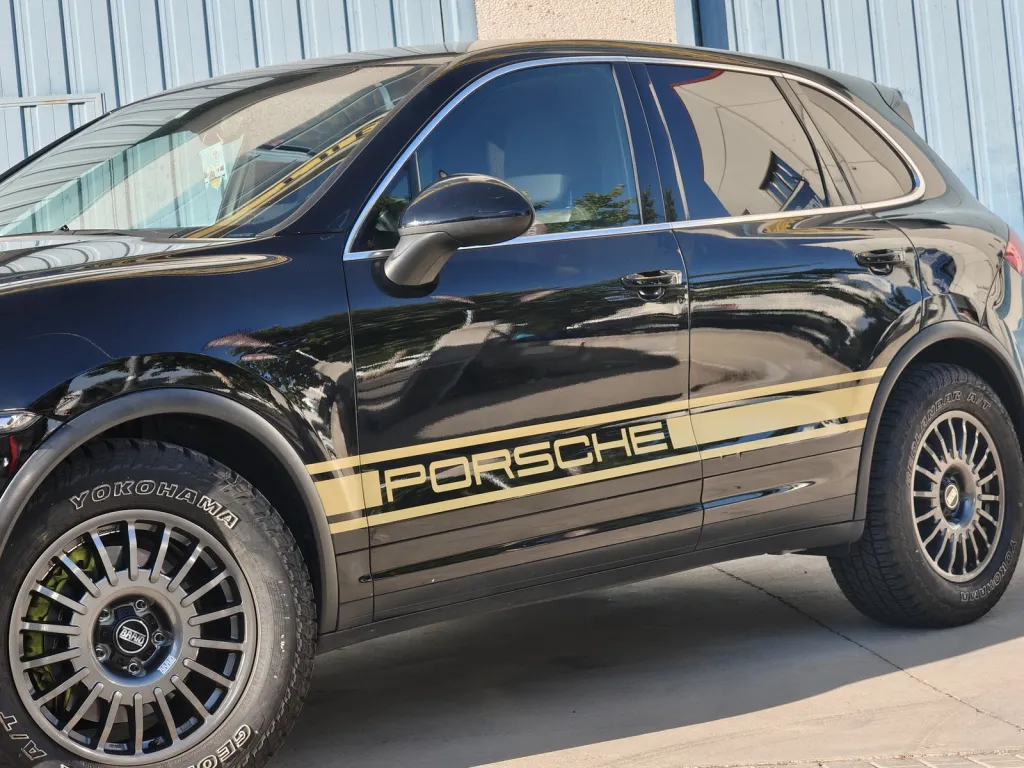 Porsche Cayenne negro con franjas laterales doradas de vinilo